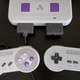 The Super Nt works with both the original Super Nintendo controllers, third-party alternatives, or 8Bitdo’s wireless gamepads.